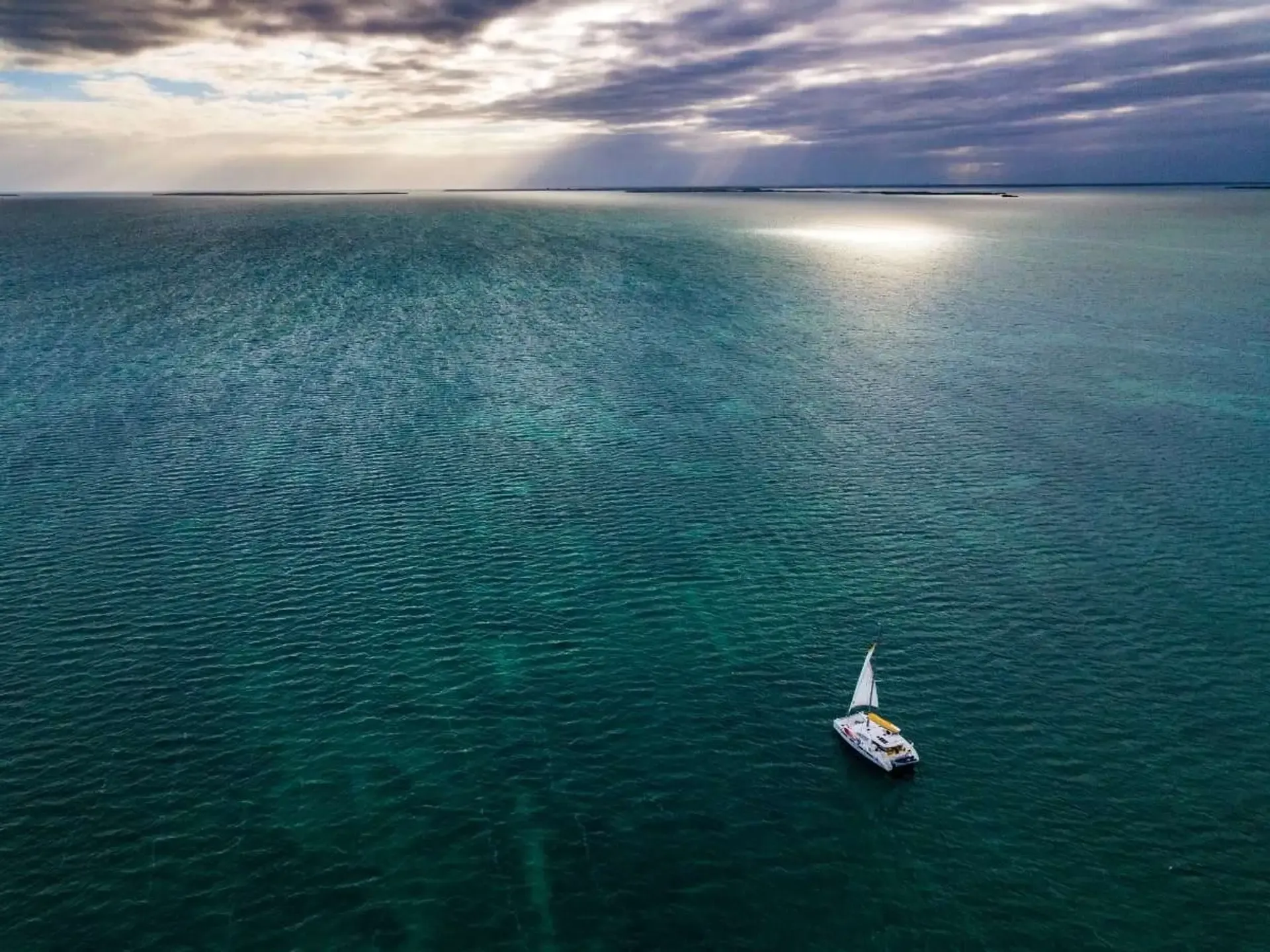 Offshore fishing charter boat heading into open water out of Placencia, Belize, for sailfish and marlin