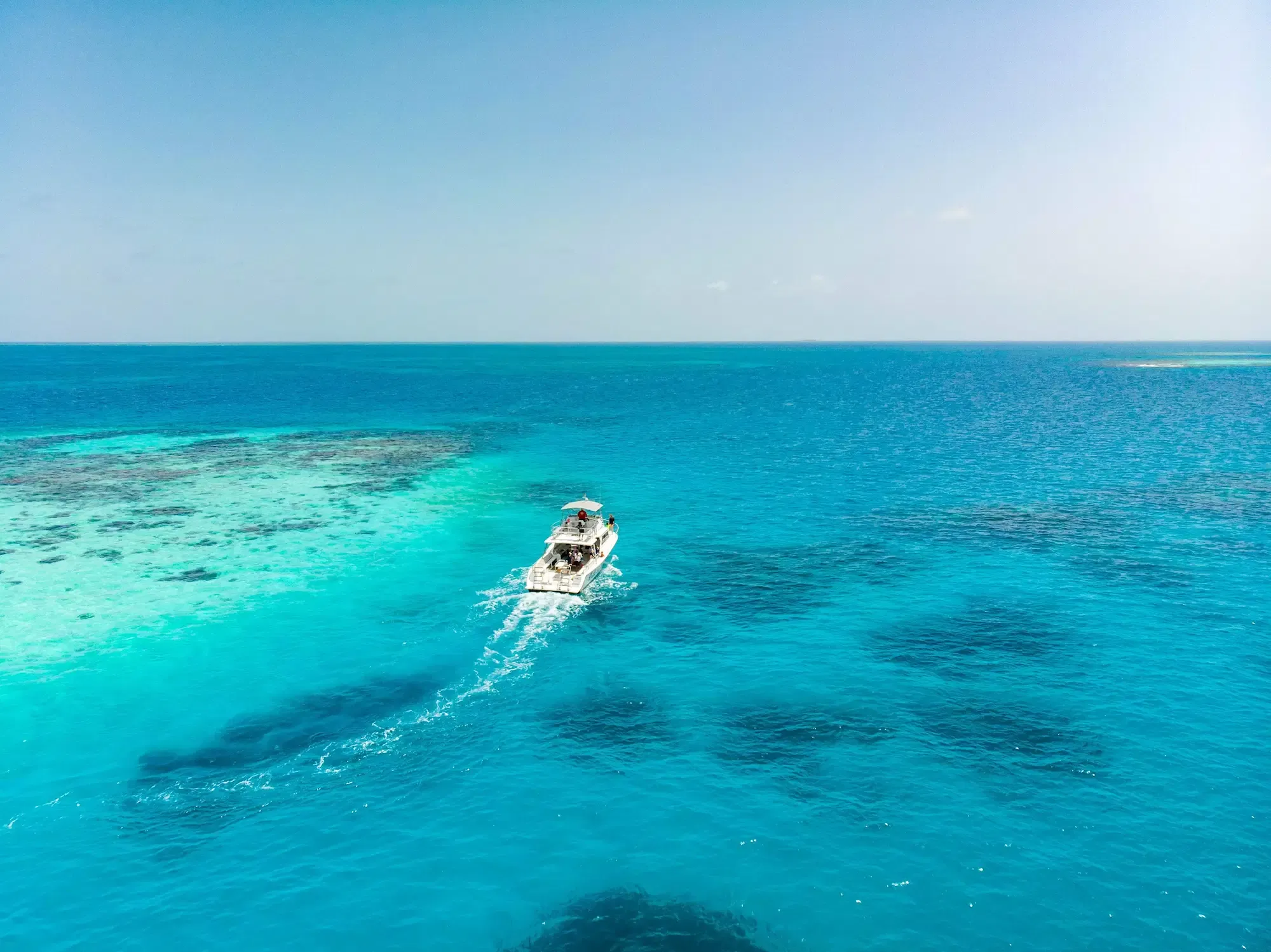 Offshore sportfishing charter boat running south into open Caribbean water out of Placencia, Belize