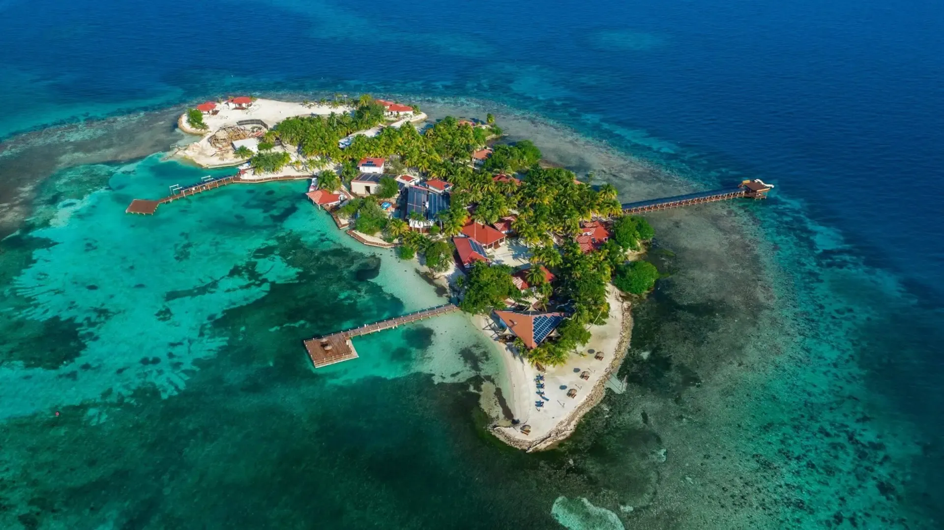 Aerial view of the Placencia Peninsula, southern Belize — the offshore fishing base with Caribbean Sea to the east and Placencia Lagoon to the west
