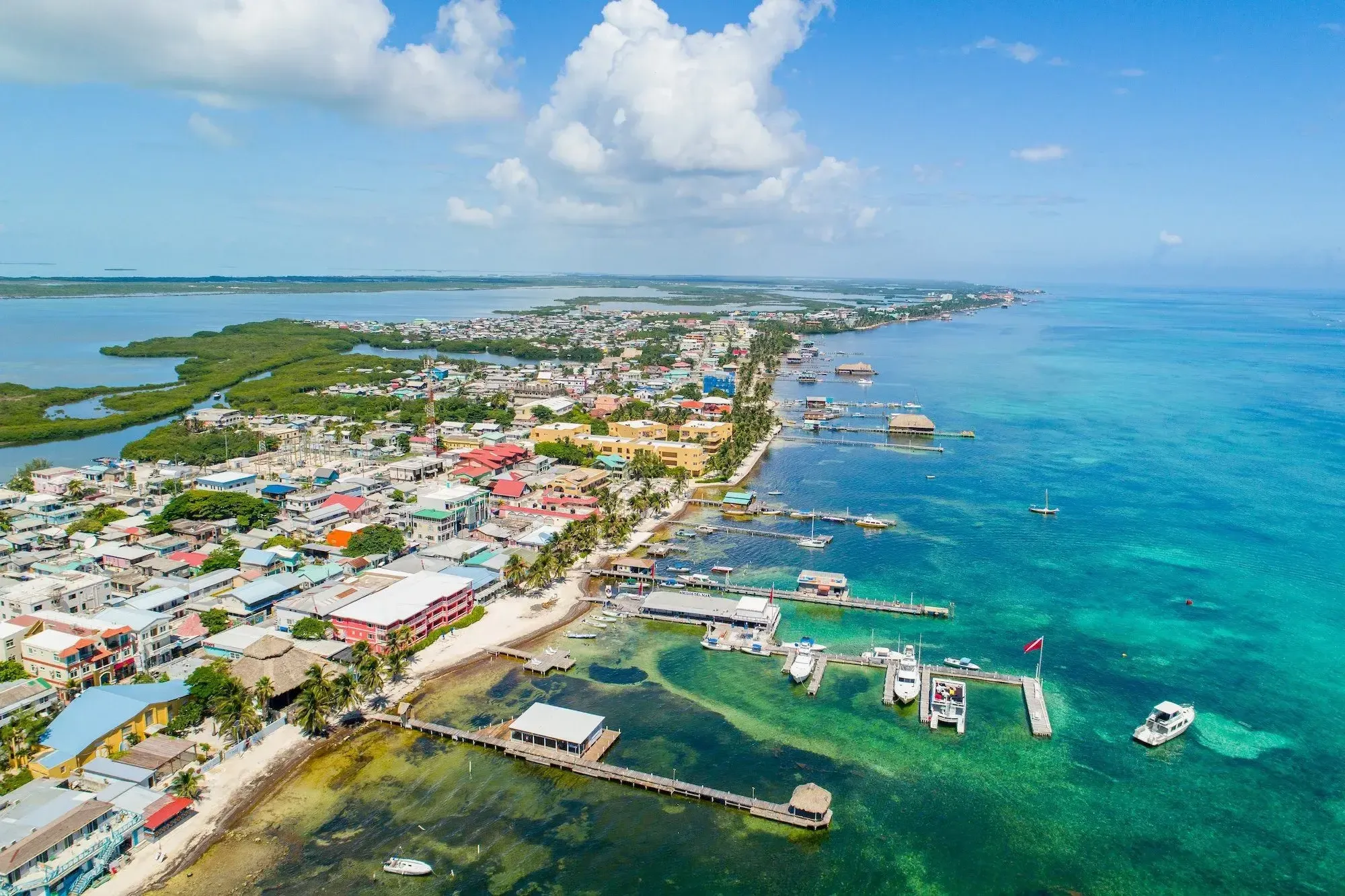 San Pedro flats at dawn, Ambergris Caye, Belize — mirror-calm water catching the first light