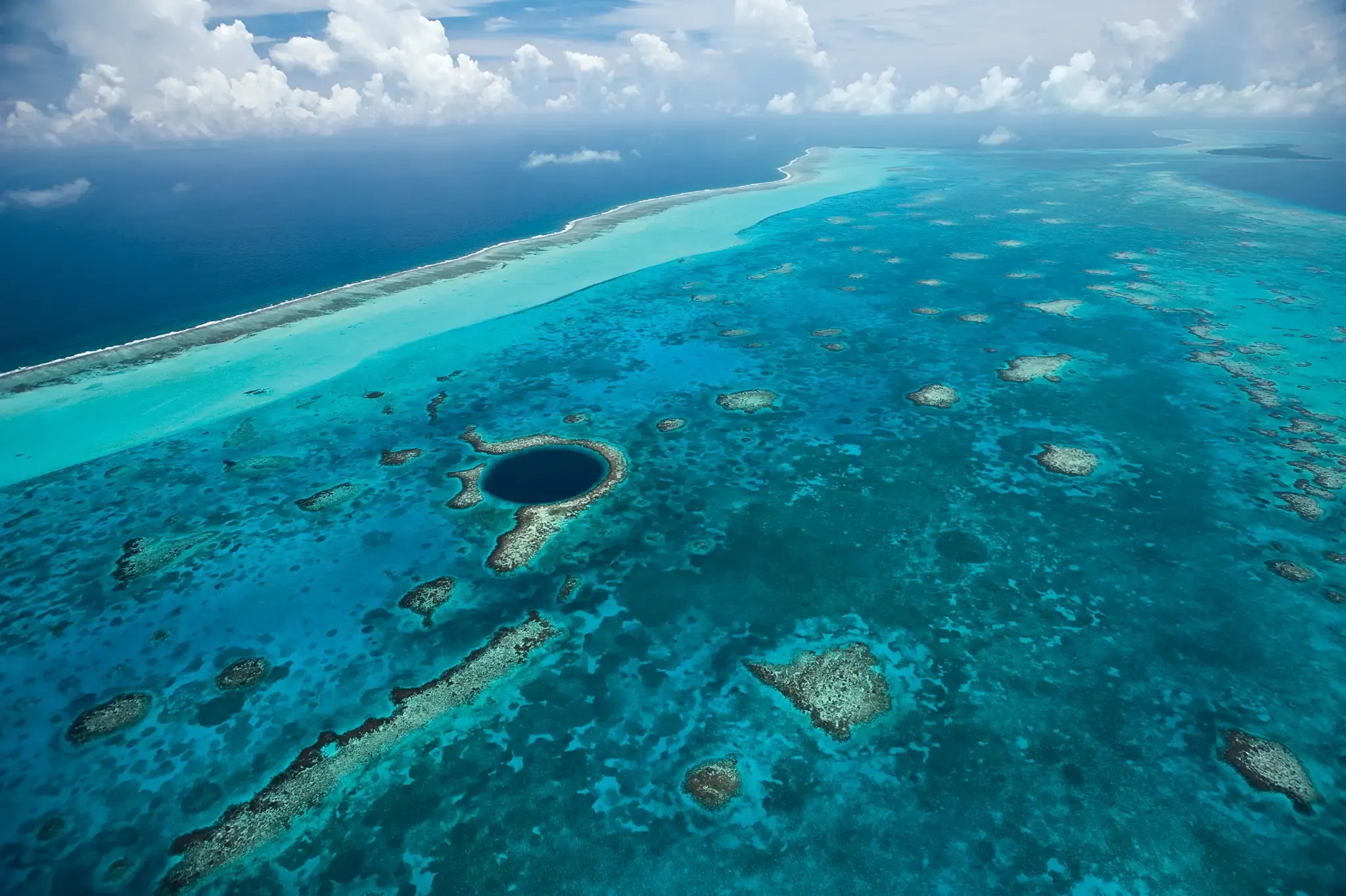 View from the Belizean flats looking east toward the barrier reef near San Pedro — reef edge separating shallow inside water from the open Caribbean