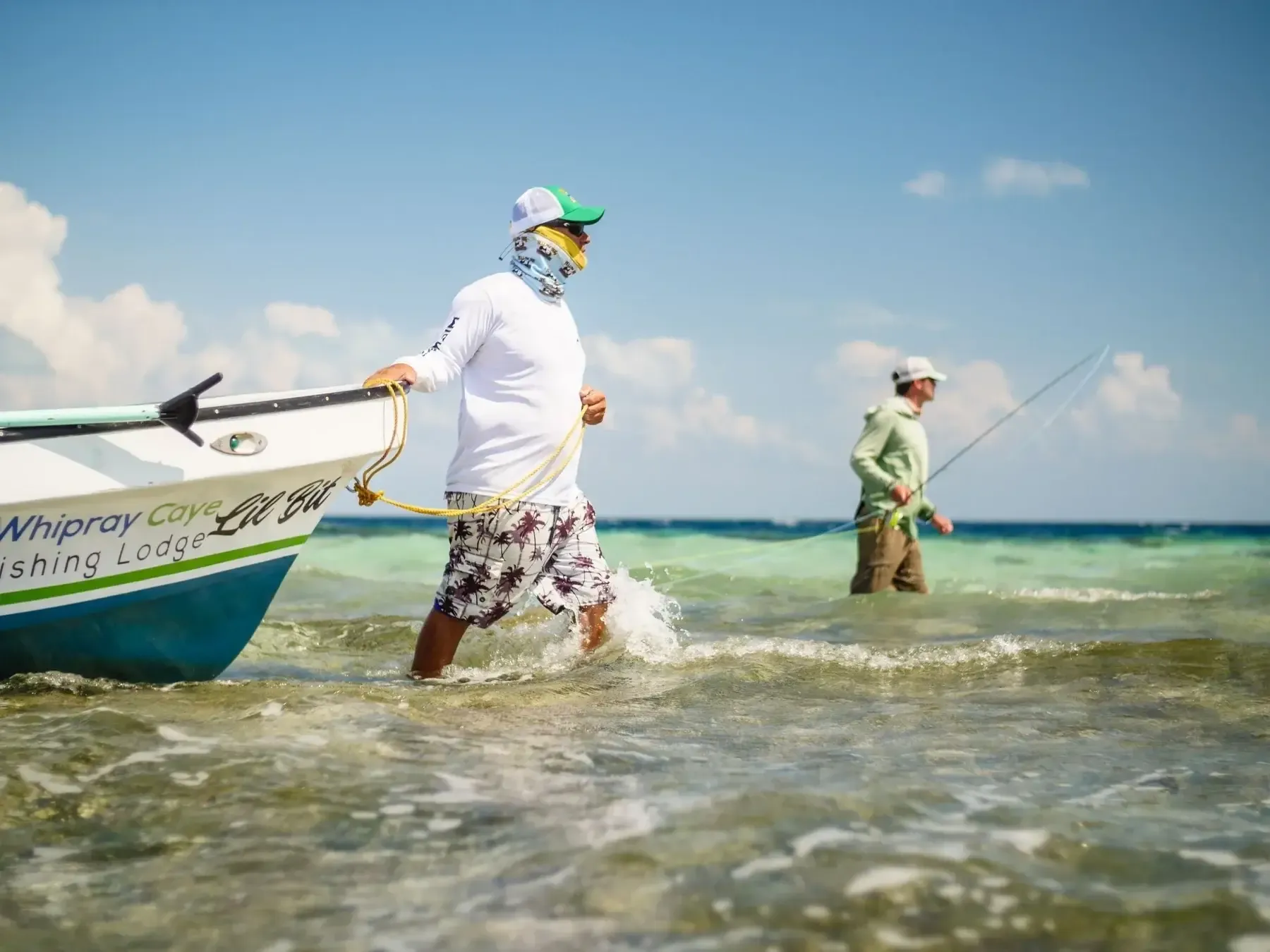 Guide poling a skiff across the flats north of San Pedro, Ambergris Caye, Belize — bonefish and permit water